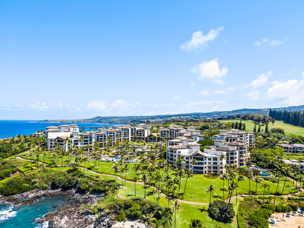 Aerial view of Montage Residences at Kapalua Bay in Maui, surrounded by lush landscapes, oceanfront views, and resort amenities.