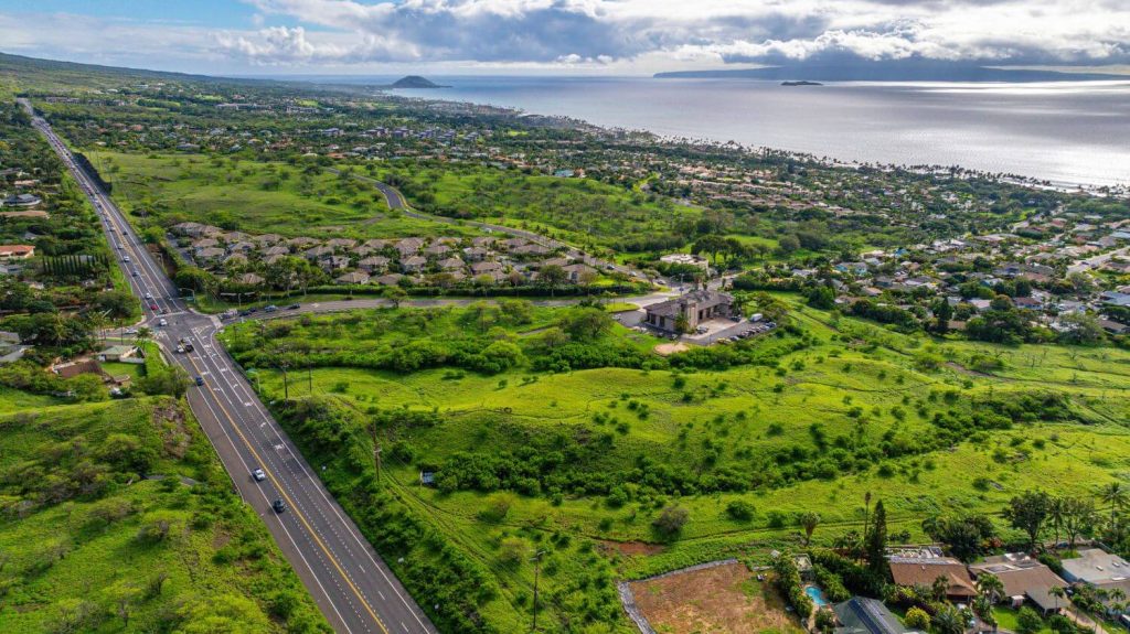 Aerial photo of Kanani Wailea showing standalone luxury condos, lush greenery, and nearby coastline in South Maui, Hawaii