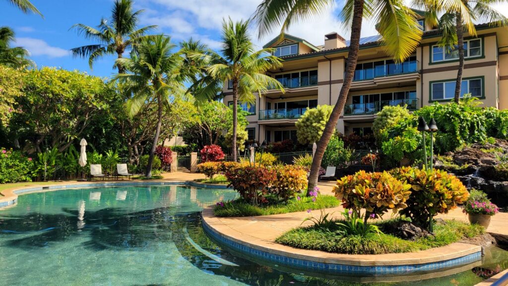 Na Hale O Makena swimming pool surrounded by tropical landscaping and luxury condo residences in Makena, Maui